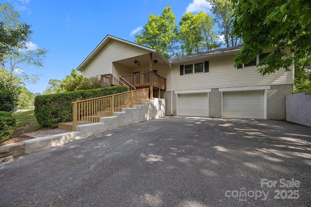 16 Lake Forest Ln, Hendersonville, NC 28739 - view of front of home with a garage, asphalt driveway, and stairway