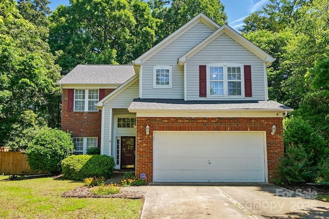 8744 Barrister Way, Charlotte, NC 28216 - traditional-style house with brick siding, concrete driveway, fence, a garage, and a shingled roof