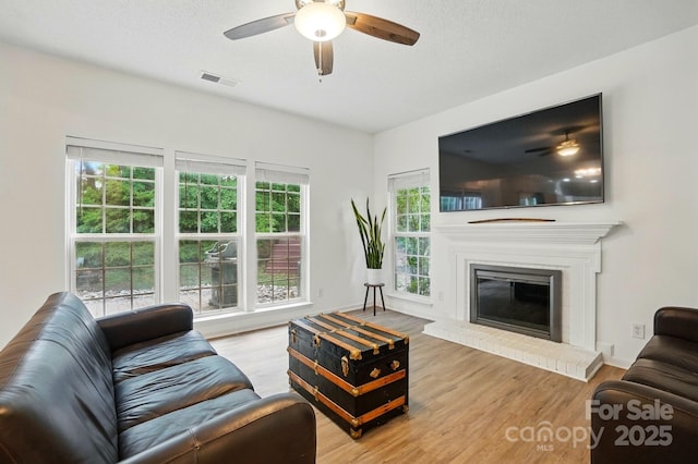 8744 Barrister Way, Charlotte, NC 28216 - living area with ceiling fan, wood finished floors, and a fireplace