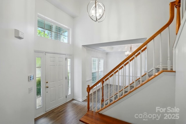 8744 Barrister Way, Charlotte, NC 28216 - foyer entrance featuring a chandelier, a high ceiling, stairway, wood finished floors, and baseboards