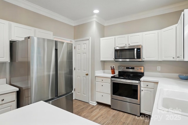 8744 Barrister Way, Charlotte, NC 28216 - kitchen featuring stainless steel appliances, ornamental molding, light countertops, light wood finished floors, and white cabinetry