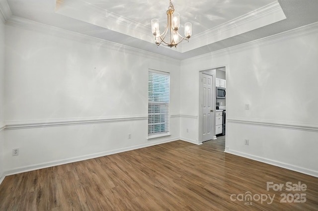 8744 Barrister Way, Charlotte, NC 28216 - unfurnished room with wood finished floors, a chandelier, a tray ceiling, ornamental molding, and baseboards
