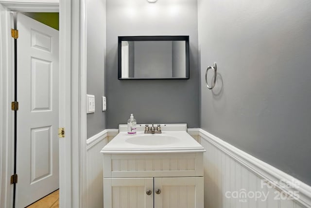 8744 Barrister Way, Charlotte, NC 28216 - bathroom featuring a wainscoted wall, vanity, and a decorative wall