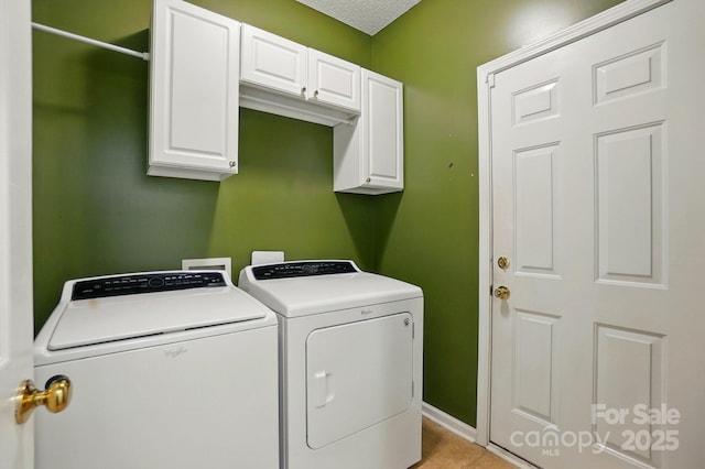 8744 Barrister Way, Charlotte, NC 28216 - washroom featuring washing machine and clothes dryer, cabinet space, and light tile patterned flooring