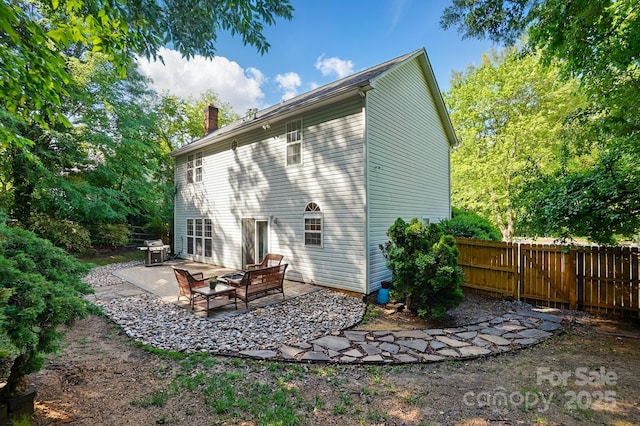 8744 Barrister Way, Charlotte, NC 28216 - back of house with a patio, fence, and a chimney