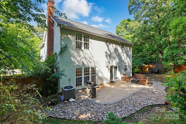 8744 Barrister Way, Charlotte, NC 28216 - rear view of property featuring a chimney, fence, a patio, and central air condition unit