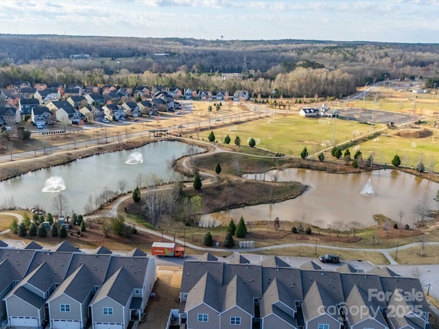 aerial view of residential area featuring a large body of water