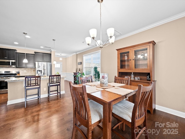 dining space with ornamental molding, a chandelier, dark wood-style floors, recessed lighting, and baseboards