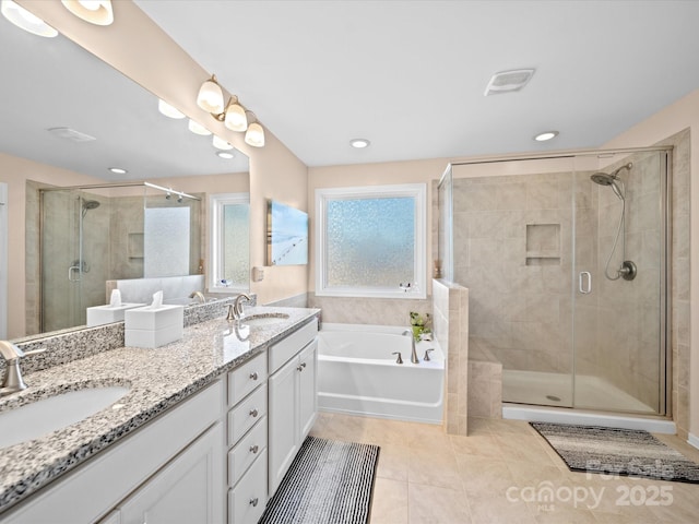 full bath featuring tile patterned floors, a stall shower, a garden tub, double vanity, and recessed lighting