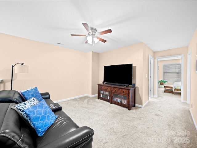 living area featuring a ceiling fan, carpet floors, and baseboards
