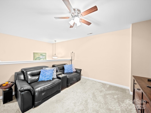 carpeted living room featuring a ceiling fan and baseboards