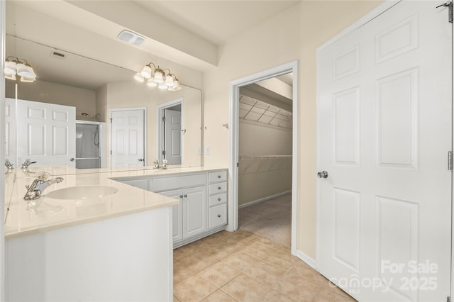 14853 Santa Lucia Dr, Charlotte, NC 28277 - bathroom featuring a shower stall, tile patterned floors, two vanities, and a walk in closet