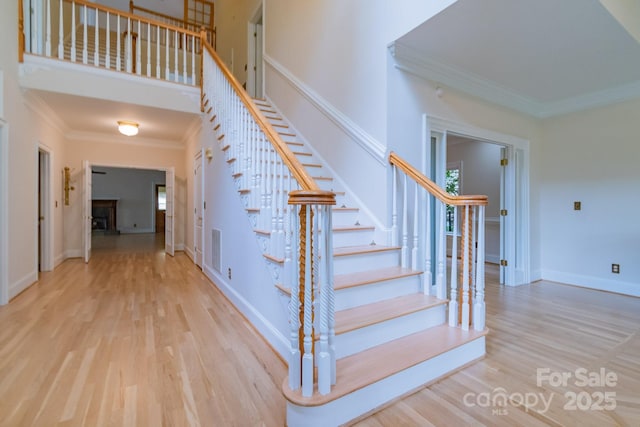 416 E Park Ave, Charlotte, NC 28203 - stairs featuring ornamental molding, wood finished floors, and healthy amount of natural light