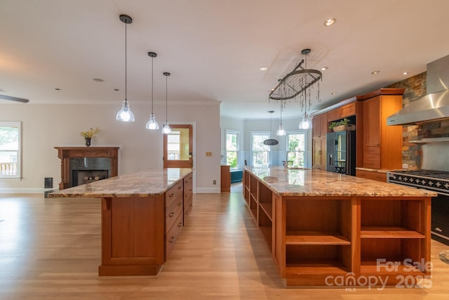 416 E Park Ave, Charlotte, NC 28203 - kitchen featuring open shelves, high end stove, wall chimney range hood, fridge with ice dispenser, and a spacious island
