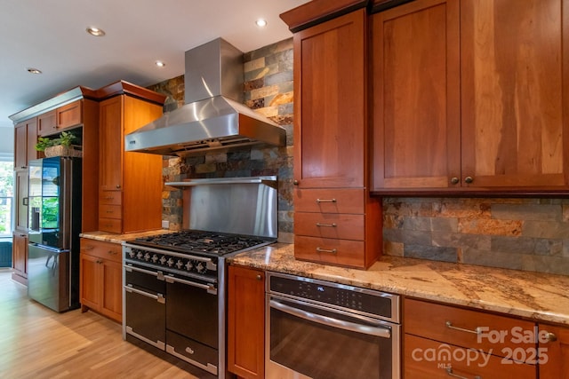 416 E Park Ave, Charlotte, NC 28203 - kitchen with range hood, stainless steel appliances, brown cabinetry, tasteful backsplash, and recessed lighting