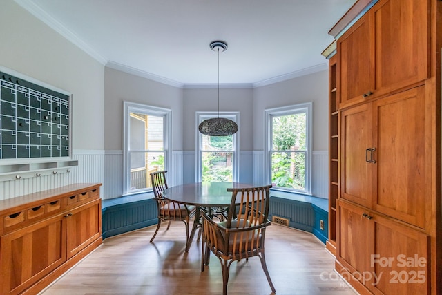 416 E Park Ave, Charlotte, NC 28203 - dining area featuring a wainscoted wall, light wood-style floors, and crown molding