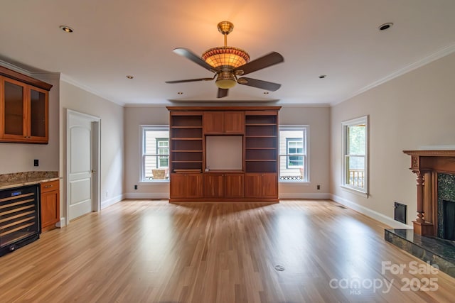 416 E Park Ave, Charlotte, NC 28203 - unfurnished living room with wine cooler, light wood-type flooring, healthy amount of natural light, ceiling fan, and ornamental molding
