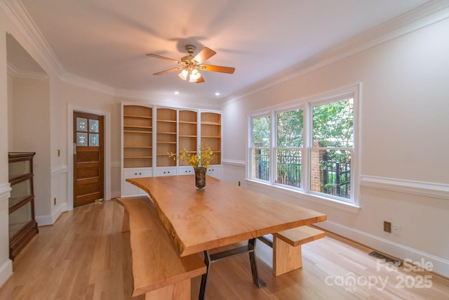 416 E Park Ave, Charlotte, NC 28203 - dining space featuring light wood-style flooring, a ceiling fan, and crown molding