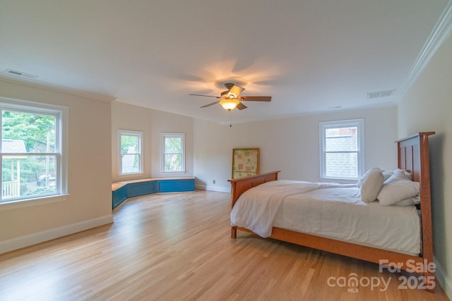 416 E Park Ave, Charlotte, NC 28203 - bedroom with multiple windows, crown molding, light wood-type flooring, and ceiling fan