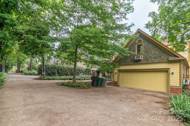 416 E Park Ave, Charlotte, NC 28203 - view of front of house featuring a garage, concrete driveway, brick siding, and cooling unit