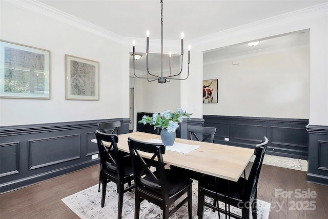 8916 Inverness Bay Rd, Charlotte, NC 28278 - dining space with a chandelier, dark wood finished floors, ornamental molding, wainscoting, and a decorative wall