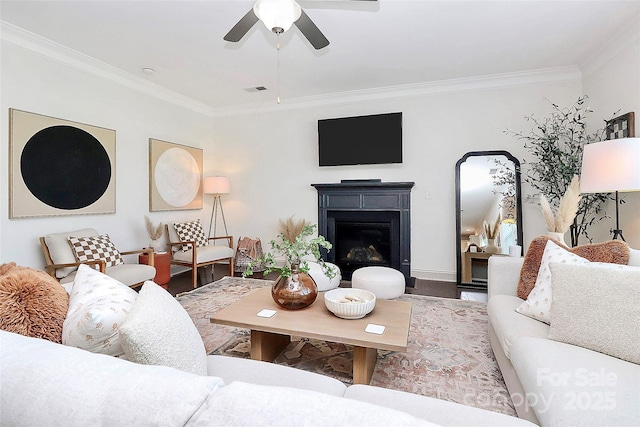 8916 Inverness Bay Rd, Charlotte, NC 28278 - living room featuring crown molding, a glass covered fireplace, a ceiling fan, wood finished floors, and baseboards