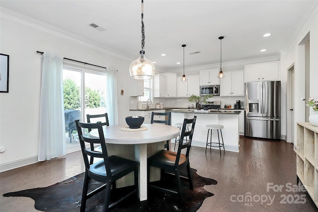 8916 Inverness Bay Rd, Charlotte, NC 28278 - dining room featuring ornamental molding, dark wood-style floors, recessed lighting, and baseboards