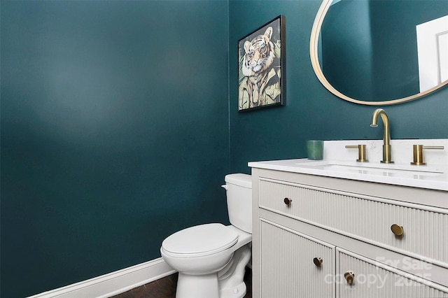 8916 Inverness Bay Rd, Charlotte, NC 28278 - half bathroom featuring toilet, vanity, and baseboards