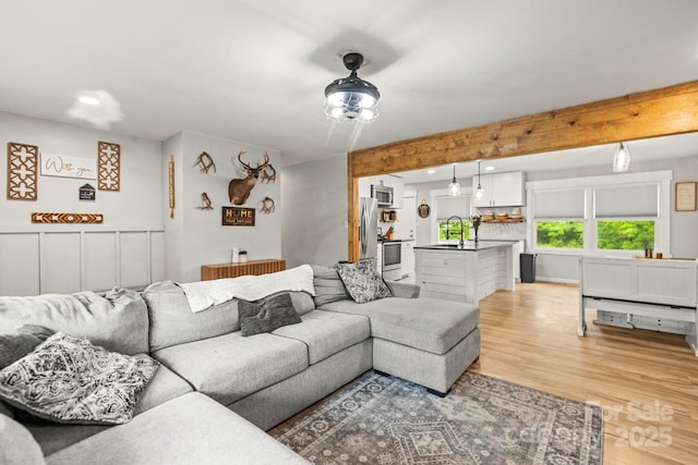 living area with light wood finished floors and recessed lighting