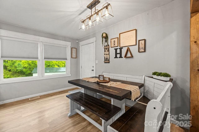 dining space featuring light wood-style flooring, baseboards, and breakfast area