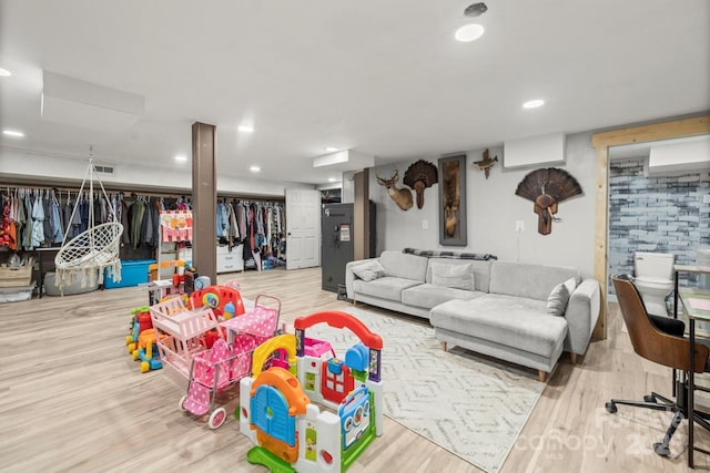 rec room with wood finished floors and recessed lighting