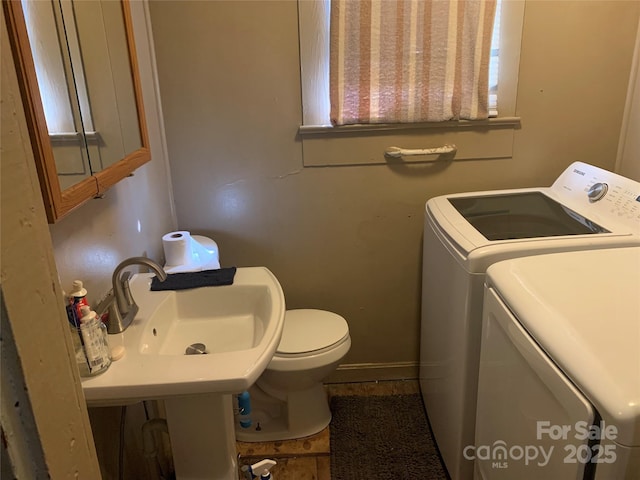 24 Pearl St Unit 8A & 8B, Granite Falls, NC 28630 - bathroom with washing machine and clothes dryer, toilet, a sink, and baseboards