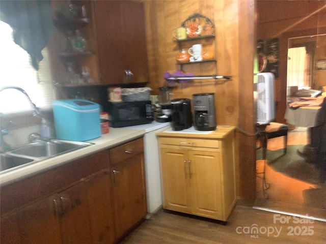 24 Pearl St Unit 8A & 8B, Granite Falls, NC 28630 - kitchen featuring black microwave, a sink, light countertops, wood finished floors, and open shelves