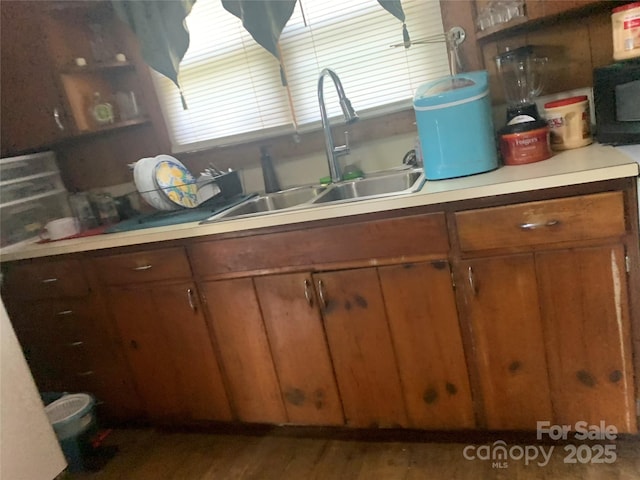 24 Pearl St Unit 8A & 8B, Granite Falls, NC 28630 - kitchen featuring a sink, wood finished floors, light countertops, brown cabinetry, and open shelves