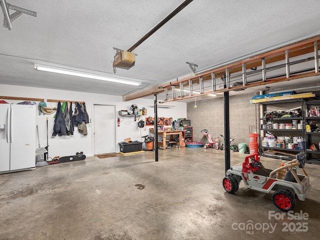 26 Morrow Dr, Fairview, NC 28730 - garage featuring white refrigerator with ice dispenser and a garage door opener