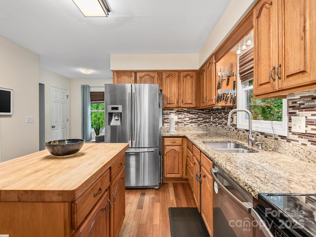 26 Morrow Dr, Fairview, NC 28730 - kitchen featuring stainless steel appliances, wooden counters, light wood finished floors, tasteful backsplash, and brown cabinets