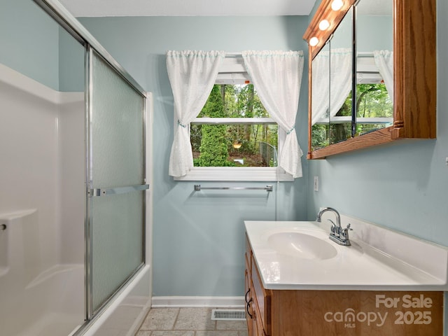 26 Morrow Dr, Fairview, NC 28730 - full bathroom with vanity, plenty of natural light, and combined bath / shower with glass door