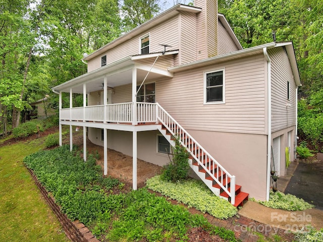 26 Morrow Dr, Fairview, NC 28730 - rear view of house featuring stairs, a chimney, a porch, and an attached garage