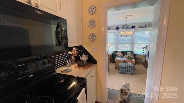 700 Valleyview Dr Unit 1, Albemarle, NC 28001 - kitchen featuring black appliances, a chandelier, decorative backsplash, and white cabinetry