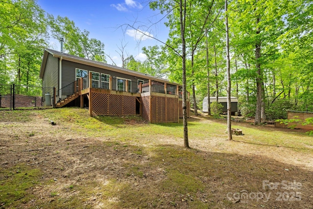 281 Crooked Creek Est, Old Fort, NC 28762 - back of property with stairs, a storage unit, an outbuilding, fence, and a sunroom