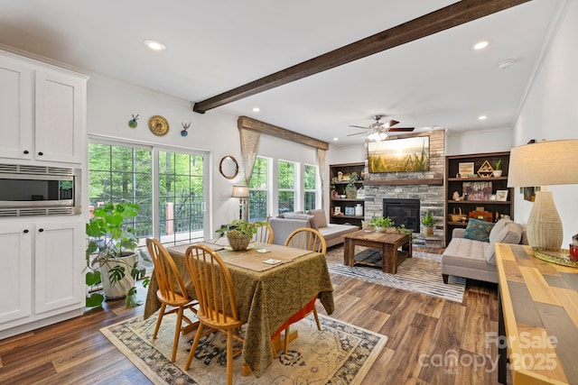281 Crooked Creek Est, Old Fort, NC 28762 - dining area featuring ornamental molding, ceiling fan, dark wood finished floors, a fireplace, and beamed ceiling