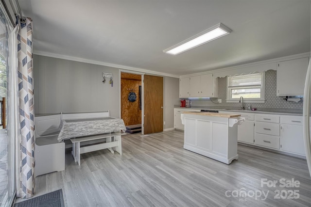 3803 Cook Rd, Valdese, NC 28690 - kitchen with light countertops, ornamental molding, white cabinetry, light wood-type flooring, and a center island