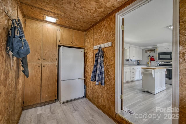 3803 Cook Rd, Valdese, NC 28690 - kitchen with freestanding refrigerator, stainless steel electric range, black microwave, light wood finished floors, and crown molding