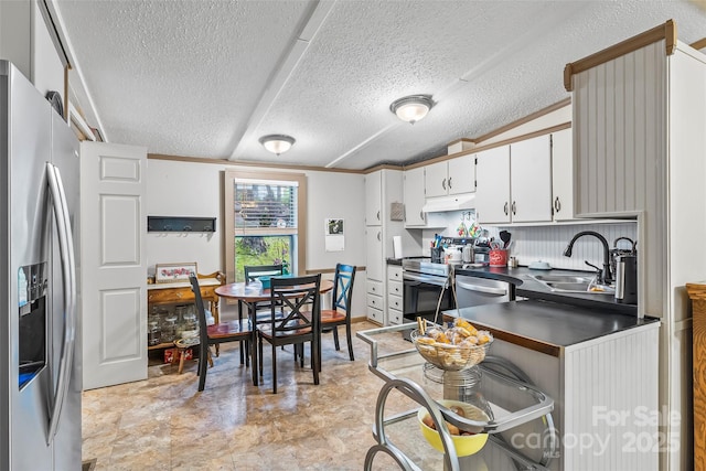 2496 Messer St, Valdese, NC 28690 - kitchen with stainless steel appliances, a sink, under cabinet range hood, dark countertops, and a textured ceiling