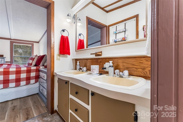 2496 Messer St, Valdese, NC 28690 - ensuite bathroom featuring double vanity, crown molding, lofted ceiling, wood finished floors, and a textured ceiling
