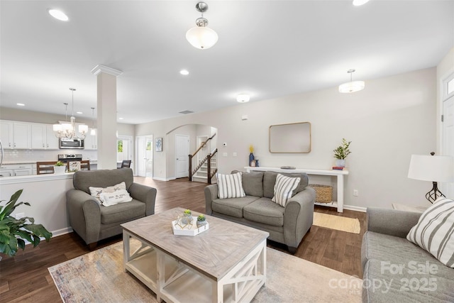 2104 New Hope Branch Way, Belmont, NC 28012 - living area featuring arched walkways, recessed lighting, wood finished floors, stairs, and a chandelier