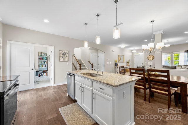 2104 New Hope Branch Way, Belmont, NC 28012 - kitchen featuring appliances with stainless steel finishes, a sink, dark wood-style floors, arched walkways, and hanging light fixtures