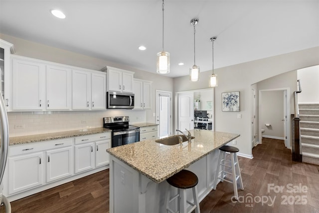 2104 New Hope Branch Way, Belmont, NC 28012 - kitchen featuring stainless steel appliances, a sink, dark wood-type flooring, white cabinetry, and a breakfast bar area
