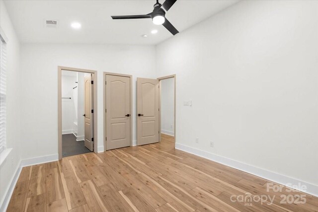 130 Valley Glen Dr, Troutman, NC 28166 - unfurnished bedroom featuring vaulted ceiling, hardwood / wood-style floors, baseboards, and a ceiling fan