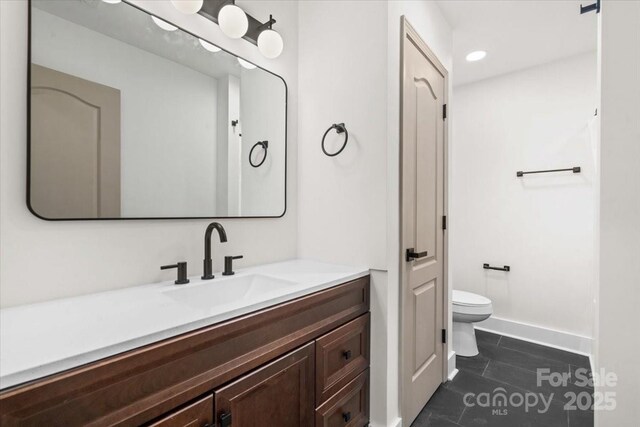 130 Valley Glen Dr, Troutman, NC 28166 - bathroom with toilet, vanity, tile patterned flooring, recessed lighting, and baseboards
